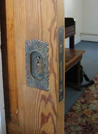 Pocket door with ornate hardware